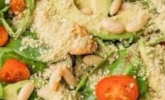 avocado slices, sprinkled with grated cheese and pine nuts, creating a fresh, appetizing look.