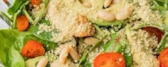 avocado slices, sprinkled with grated cheese and pine nuts, creating a fresh, appetizing look.