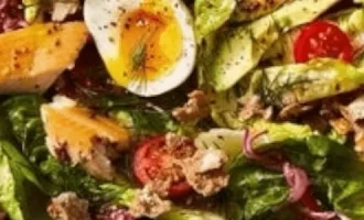 A vibrant salad featuring lettuce, cherry tomatoes.