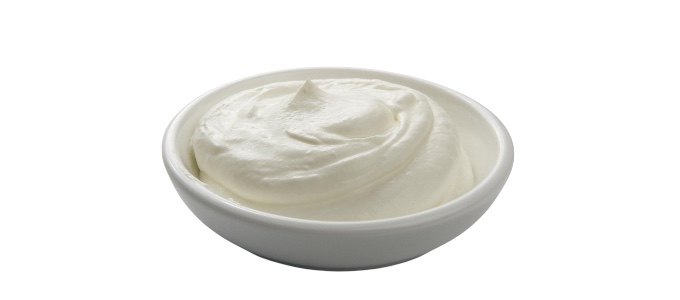 creamy yogurt or sour cream against a plain
