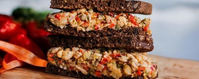 A vibrant chickpea salad sandwich with diced red peppers
