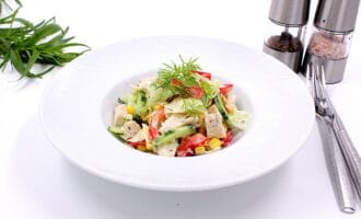 A fresh salad with chicken, cucumbers, red peppers, and corn