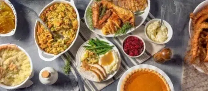 Thanksgiving feast spread on a table with turkey