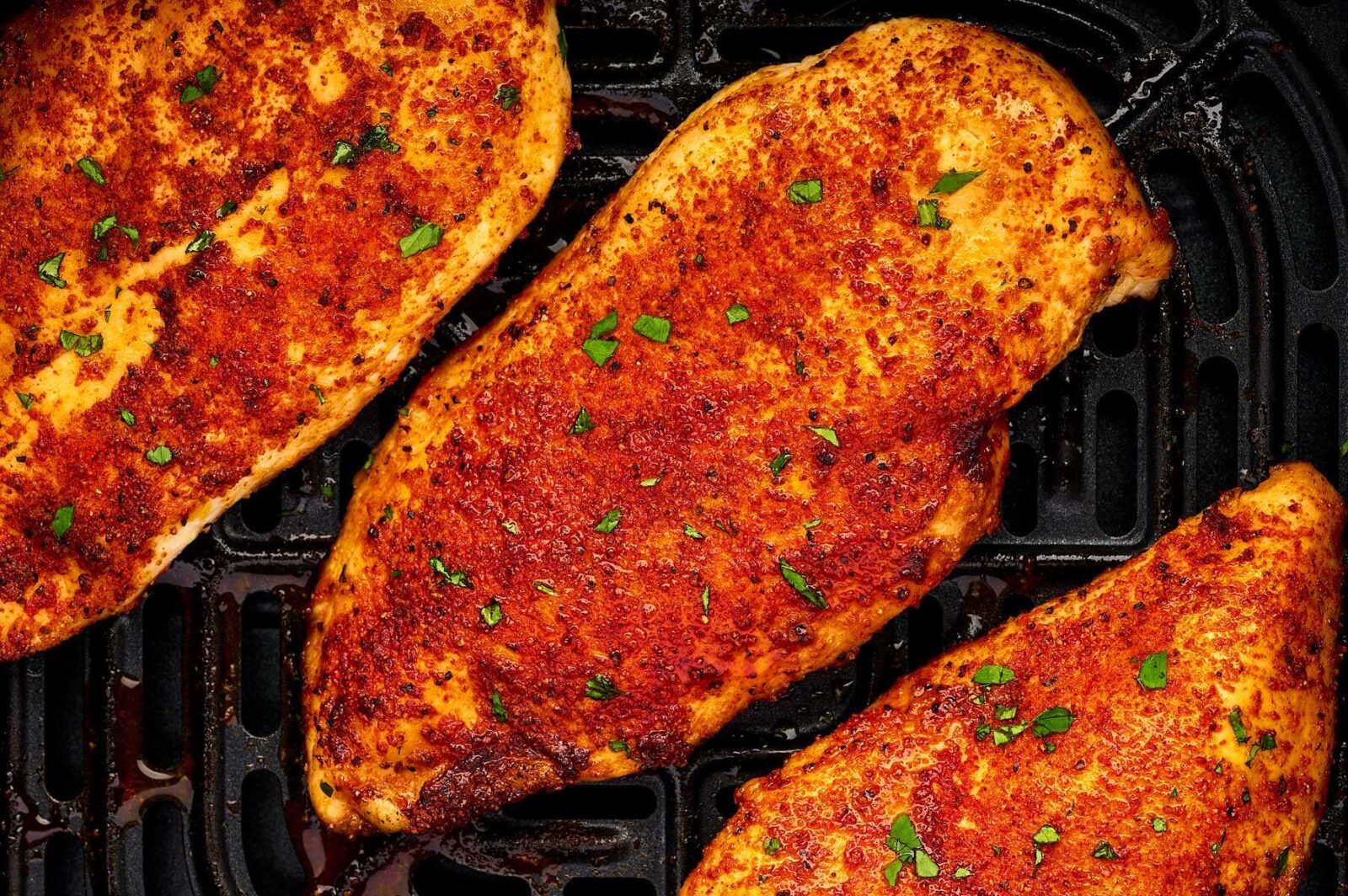 Juicy air fryer chicken breast served with herbs and lemon
