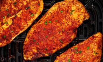 Juicy air fryer chicken breast served with herbs and lemon