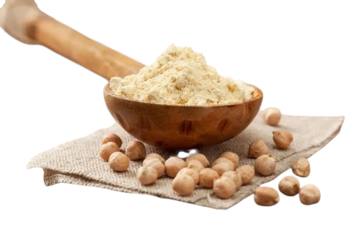 Chickpea flour in a wooden bowl with whole chickpeas