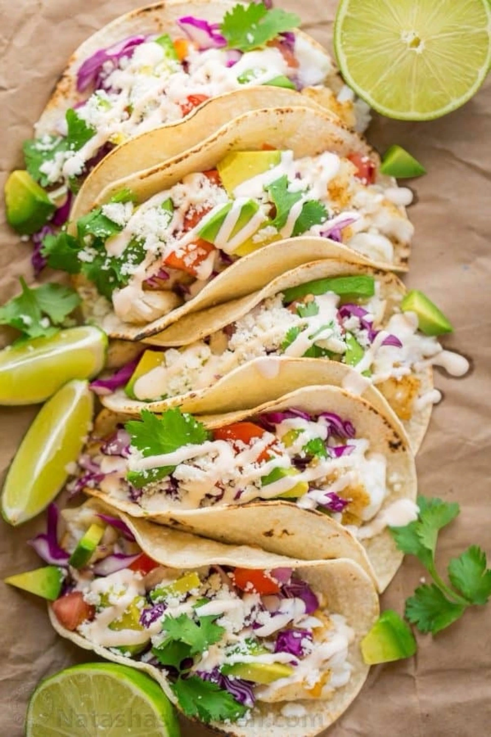 Fish tacos with creamy fish taco sauce, fresh toppings, and soft tortillas