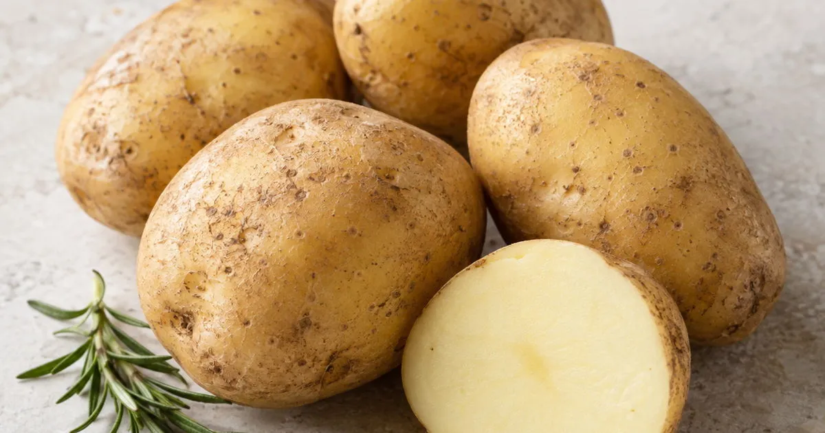 Fresh golden potatoes, whole and cut in half