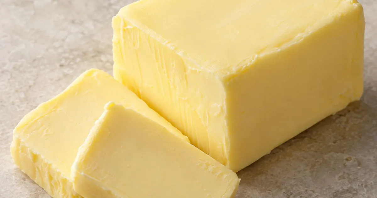 Fresh unsalted butter block with two slices