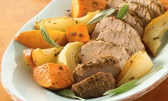 Gluten-free rosemary roasted pork with potatoes and vegetables on a plate