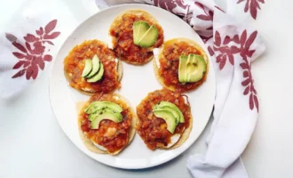 Huevos rancheros with fried eggs, tortillas, tomato salsa and avocado
