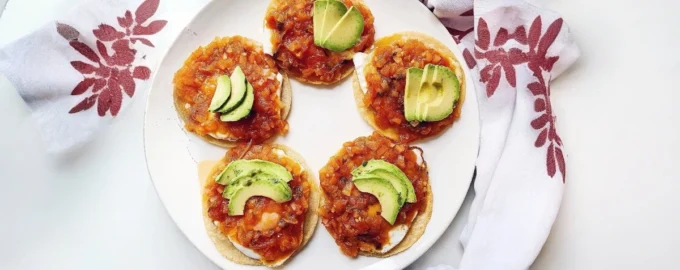 Huevos rancheros with fried eggs, tortillas, tomato salsa and avocado