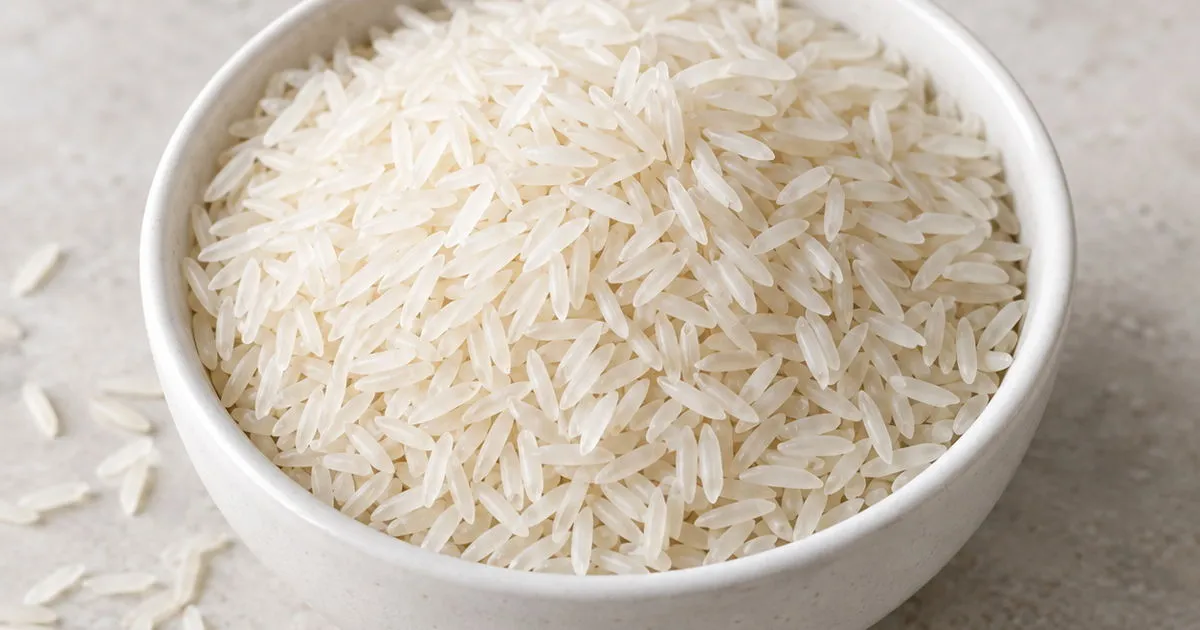 Uncooked long-grain white rice in a ceramic bowl