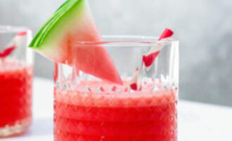 Watermelon Vodka Cocktail served over ice with fresh watermelon, lime slices, and mint leaves.