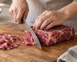 Thinly slicing beef against the grain for Korean bulgogi